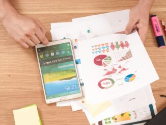 person holding white Samsung Galaxy Tab